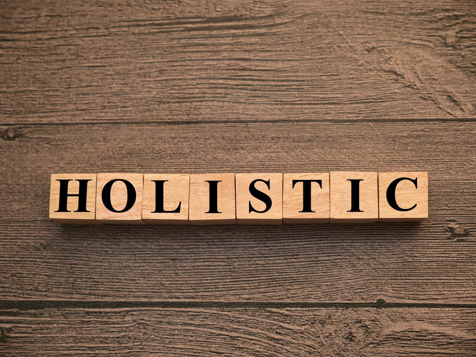 Holistic, text words typography written on wooden lettering, life and business motivational inspirational